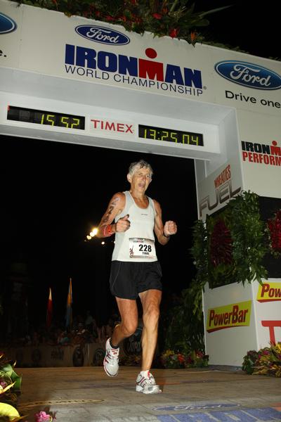 Tiare Lund going over the finish line to win the women's 65&#8212;69 years age group title at the Ironman World Championships in Hawaii yesterday